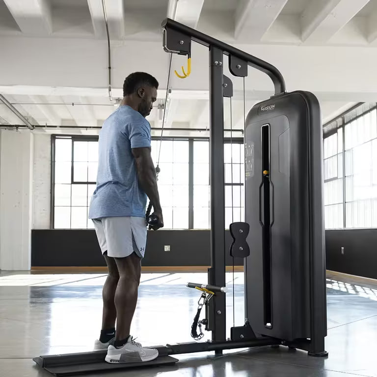 Trainee performing triceps pushdowns with a triceps rope at a Vision Fitness cable machine